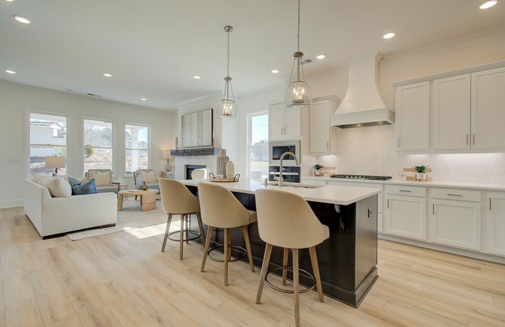 Courtyards at Traditions model home kitchen with white cabinetry and tall ceilings