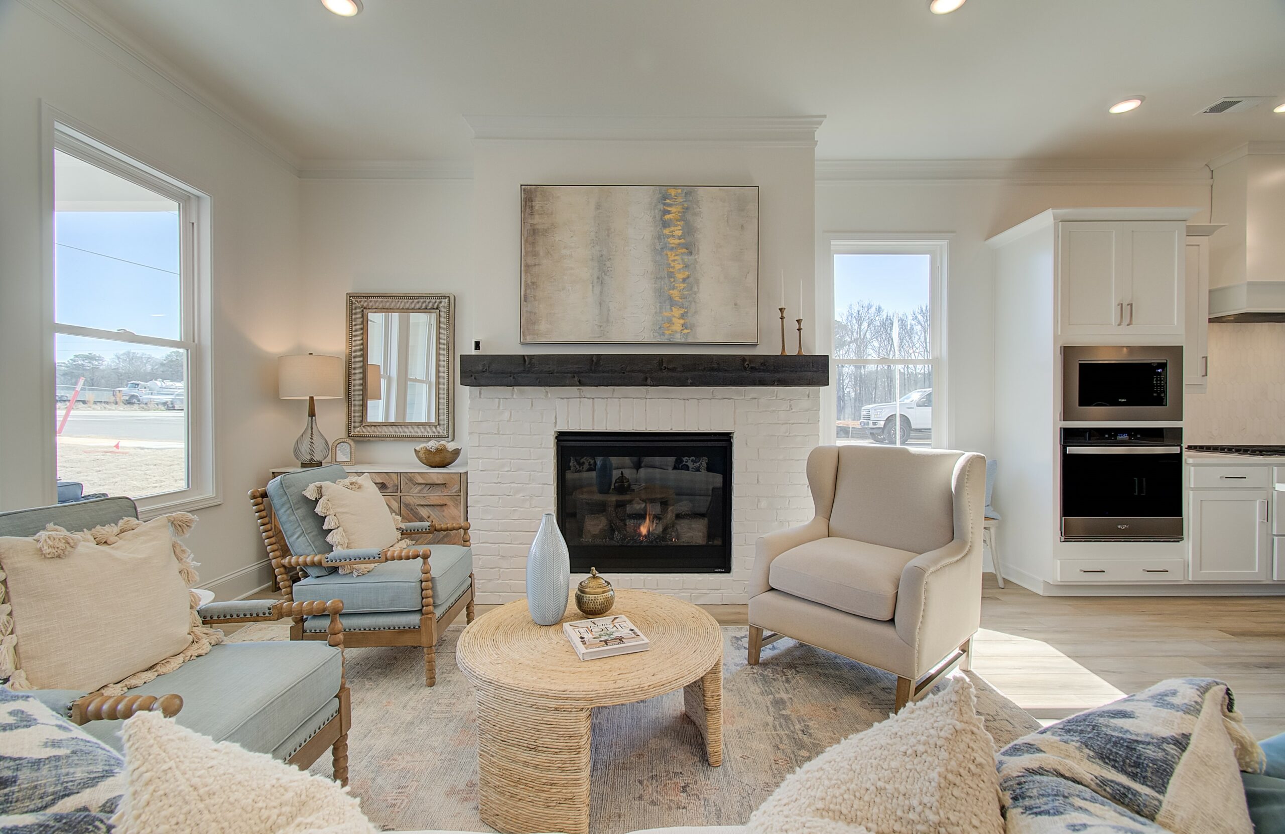 Courtyards at Traditions with white stacked stone fireplace with white walls